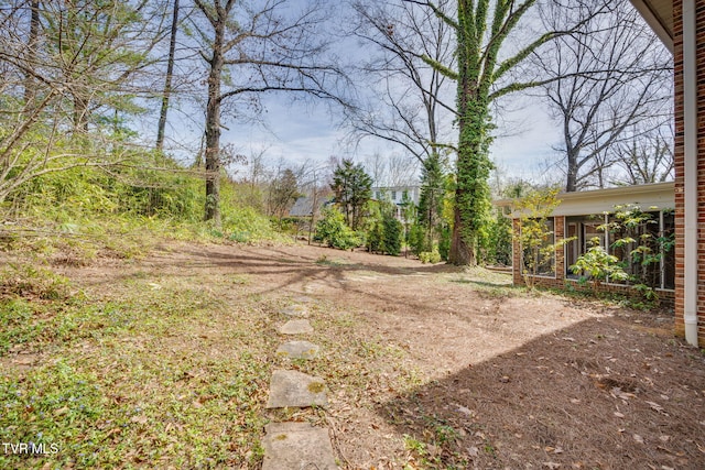 view of yard with a sunroom