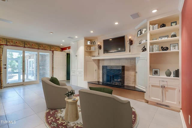living area with recessed lighting, visible vents, light tile patterned floors, and a tile fireplace