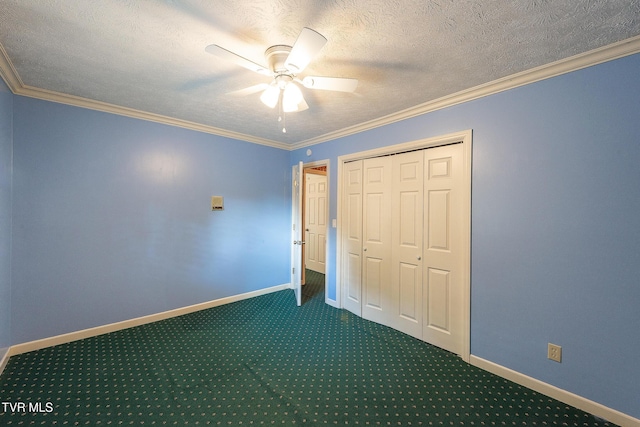 unfurnished bedroom with baseboards, ornamental molding, dark colored carpet, and a textured ceiling