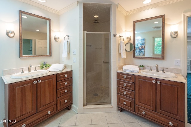 bathroom featuring ornamental molding, visible vents, a shower stall, and a sink