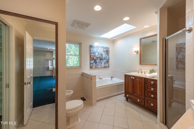full bath featuring crown molding, toilet, a skylight, and tile patterned floors