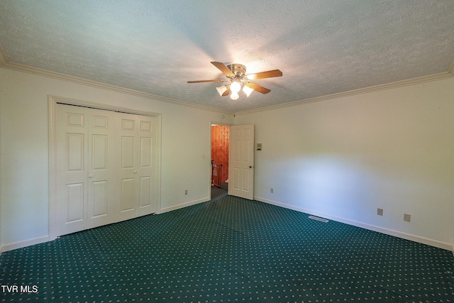 unfurnished bedroom featuring baseboards, carpet flooring, a textured ceiling, and visible vents