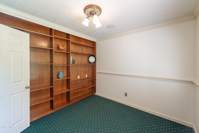 spare room with crown molding, a textured ceiling, carpet, and baseboards