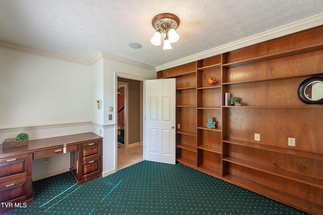 unfurnished office with dark colored carpet, a textured ceiling, built in study area, and crown molding