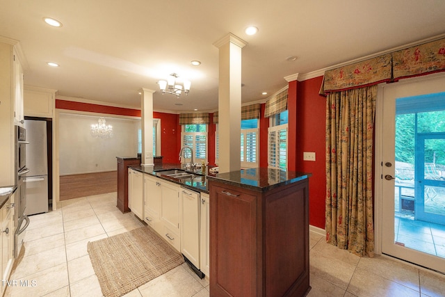 kitchen featuring crown molding, a sink, white cabinetry, and a notable chandelier