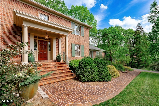property entrance with brick siding
