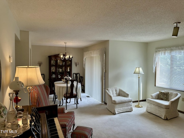 living area with carpet, an inviting chandelier, and a textured ceiling