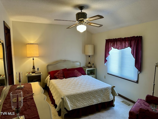 bedroom featuring visible vents, a ceiling fan, a textured ceiling, carpet, and vaulted ceiling