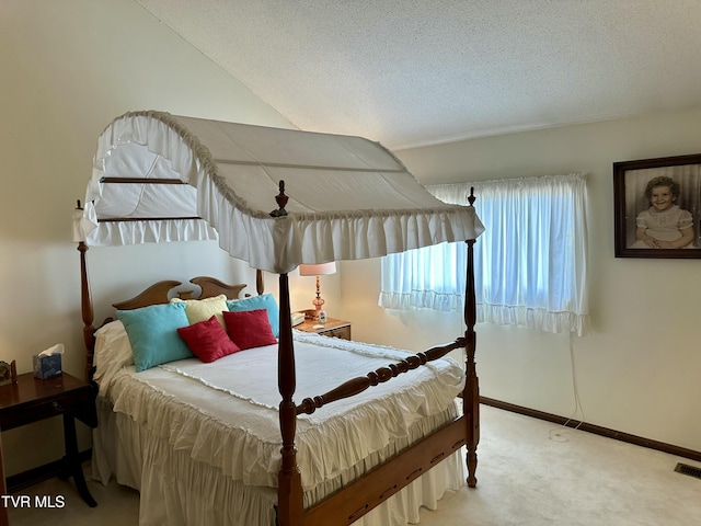 bedroom featuring baseboards, carpet floors, and a textured ceiling