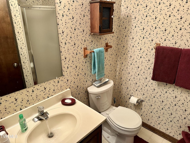 full bath featuring toilet, a stall shower, tile patterned flooring, baseboards, and vanity