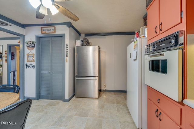 kitchen with white appliances, ceiling fan, and crown molding