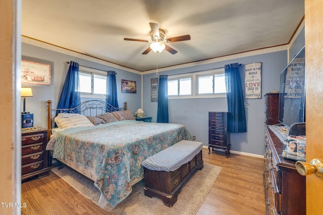 bedroom with ceiling fan, wood finished floors, baseboards, and ornamental molding