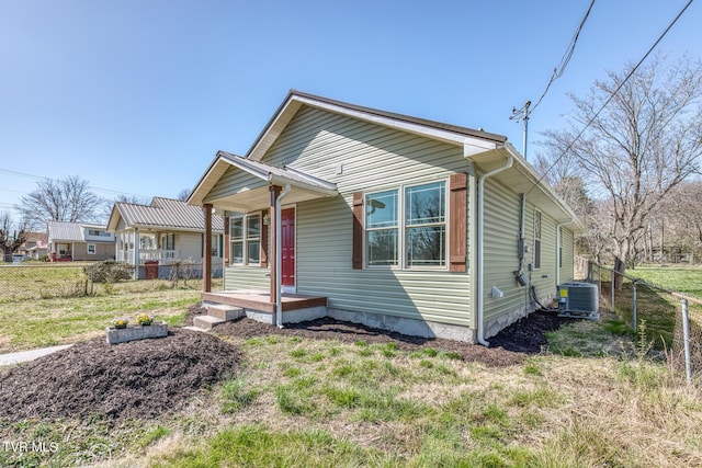 view of front of house with cooling unit and fence