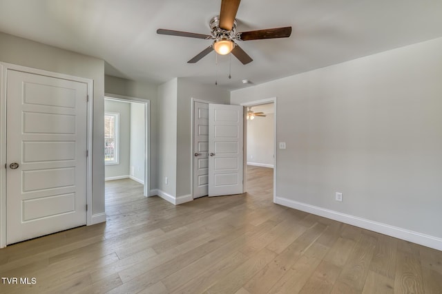 unfurnished bedroom with a ceiling fan, baseboards, and light wood finished floors