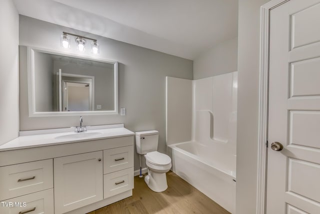 full bath featuring shower / tub combination, toilet, vanity, and wood finished floors