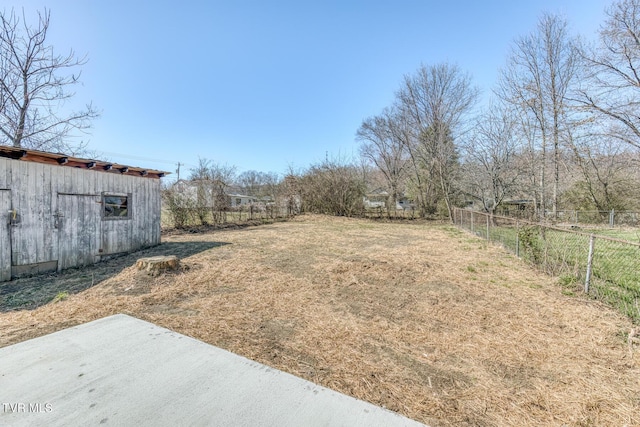 view of yard with an outbuilding, an outdoor structure, and fence