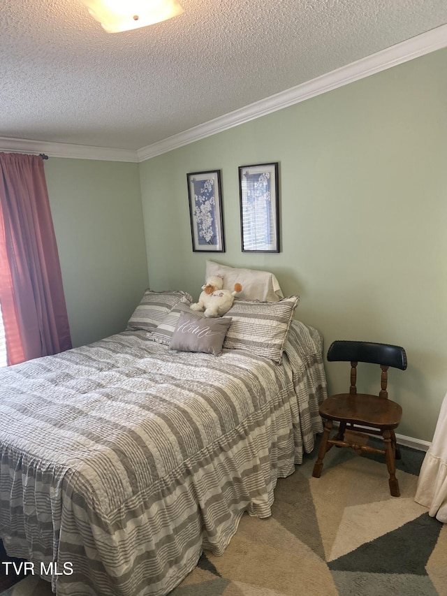 bedroom with ornamental molding, a textured ceiling, and carpet floors