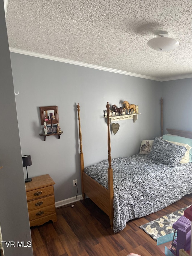 bedroom with baseboards, a textured ceiling, wood finished floors, and crown molding