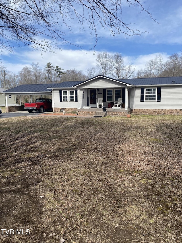 view of front of home featuring crawl space, an attached carport, and a porch