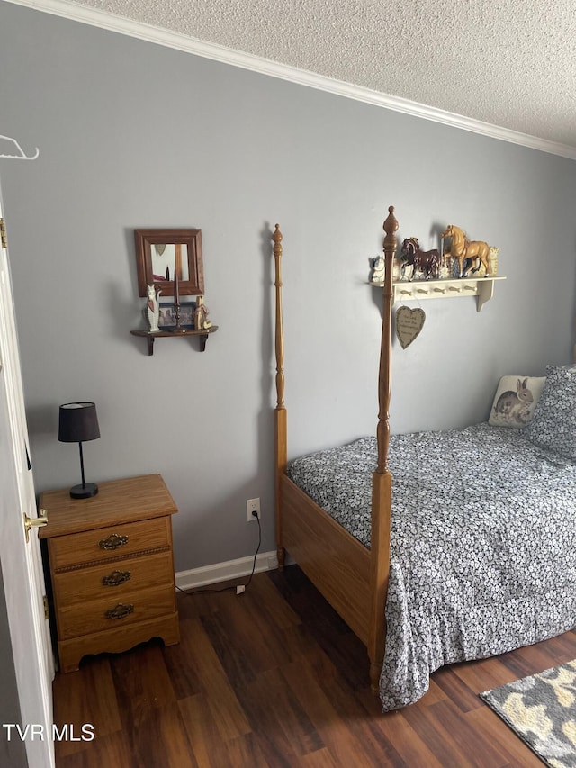 bedroom featuring crown molding, wood finished floors, baseboards, and a textured ceiling