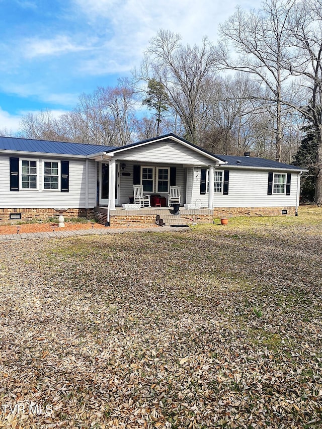 manufactured / mobile home featuring crawl space, a porch, and metal roof