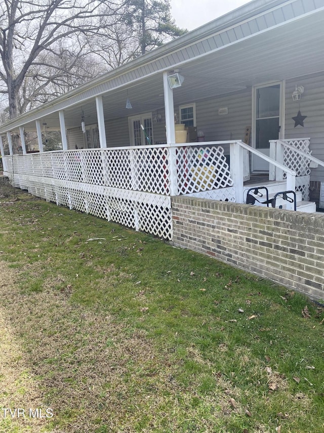 view of side of property with a lawn