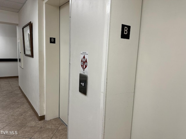 hall with light tile patterned floors