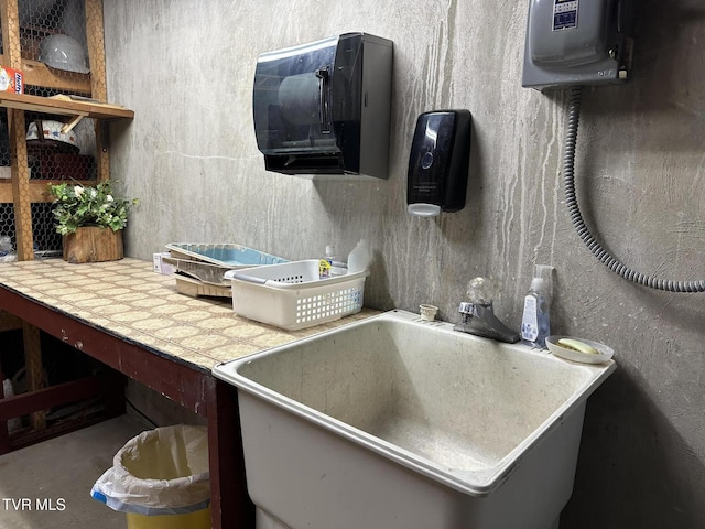 kitchen featuring tile countertops and a sink