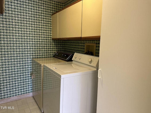 laundry area with cabinet space and separate washer and dryer