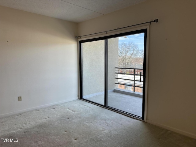 spare room with baseboards and carpet flooring