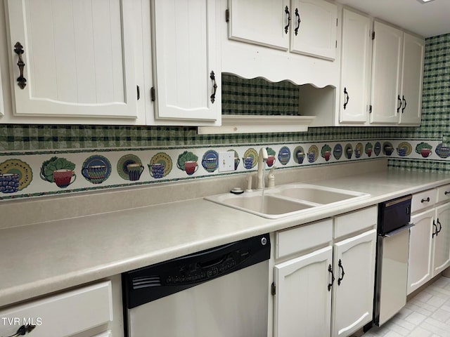 kitchen featuring dishwasher, light countertops, white cabinetry, and a sink