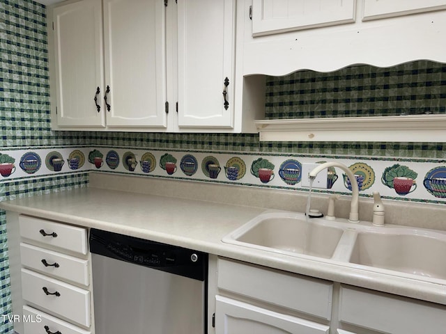 kitchen with a sink, white cabinetry, light countertops, and stainless steel dishwasher