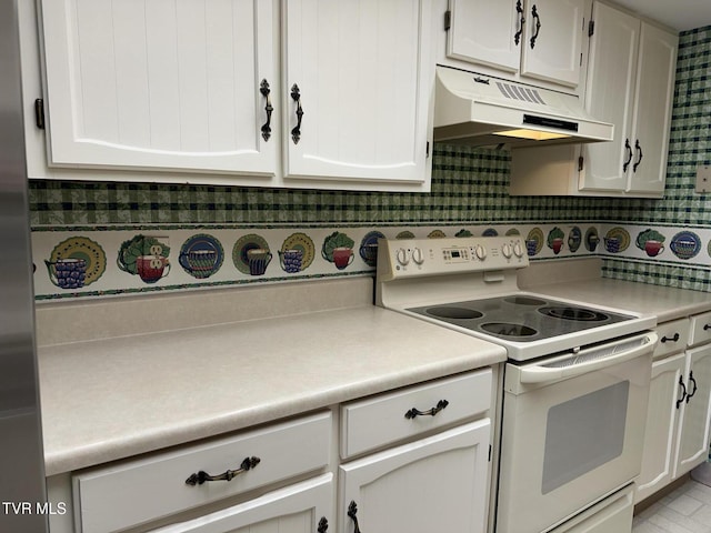 kitchen featuring under cabinet range hood, electric range, white cabinets, and light countertops