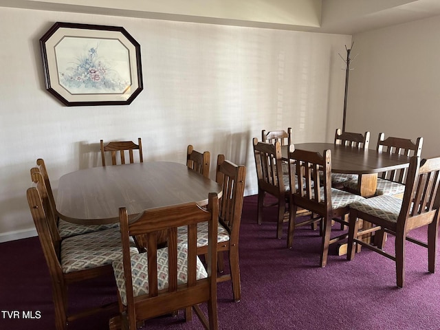 dining area with dark colored carpet