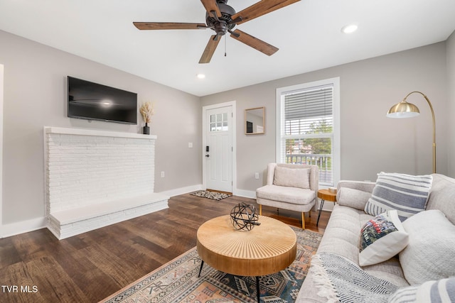 living area with recessed lighting, baseboards, and wood finished floors