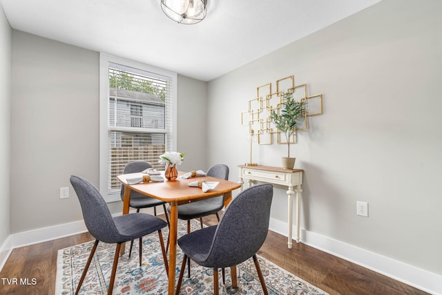 dining area featuring baseboards and dark wood-style floors