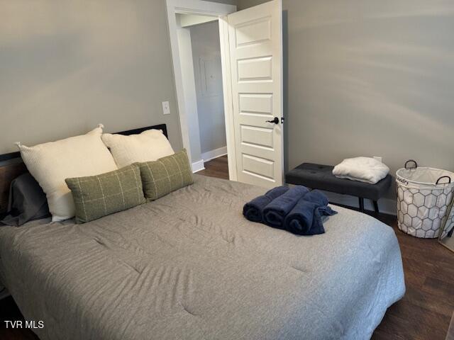 bedroom featuring wood finished floors and baseboards