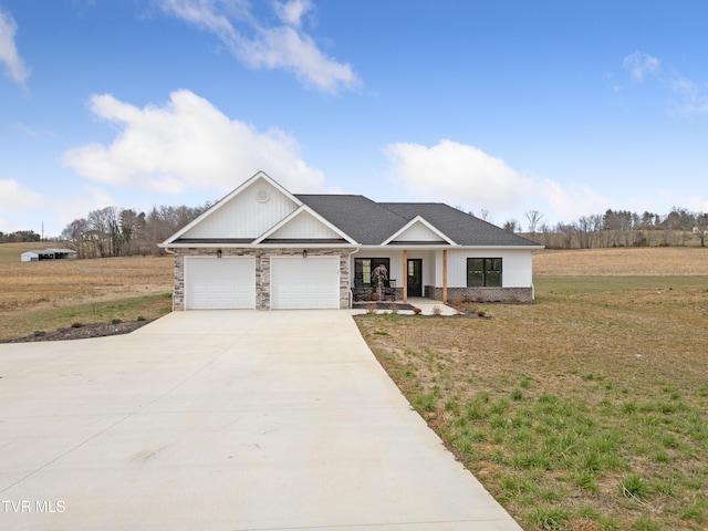 view of front facade featuring covered porch, driveway, a front lawn, and a garage