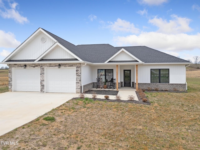 view of front of house with a porch, concrete driveway, roof with shingles, a front yard, and an attached garage