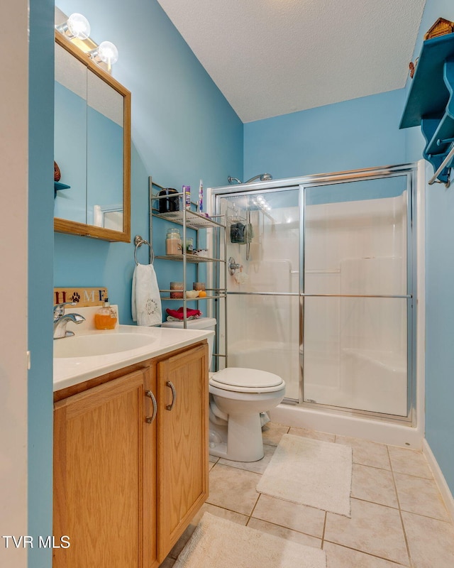 full bath with vanity, a shower stall, toilet, and tile patterned floors