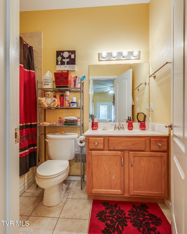 full bath featuring curtained shower, toilet, vanity, and tile patterned flooring