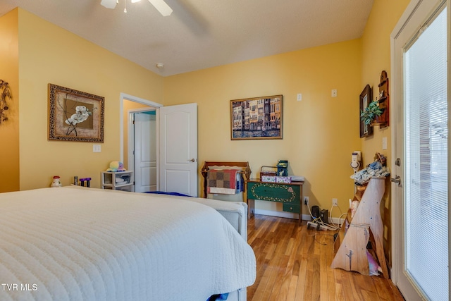 bedroom with ceiling fan, baseboards, and wood finished floors