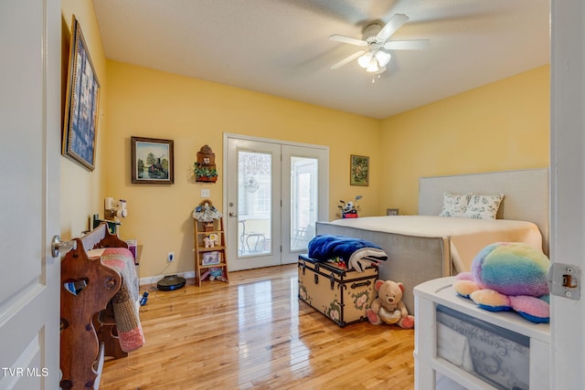 bedroom featuring access to exterior, baseboards, light wood-type flooring, and ceiling fan