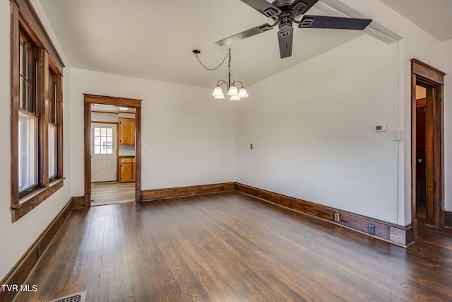 unfurnished room with baseboards, dark wood-style floors, and ceiling fan with notable chandelier