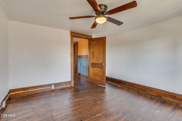 unfurnished room with a ceiling fan, wood finished floors, and baseboards