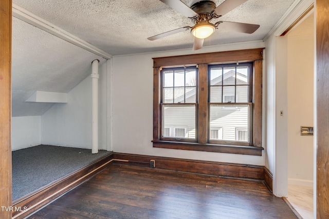 bonus room with hardwood / wood-style flooring, vaulted ceiling, and a textured ceiling