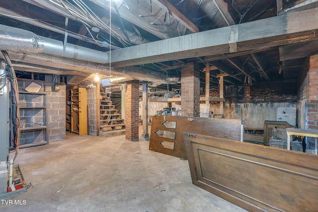 unfinished basement featuring stairs