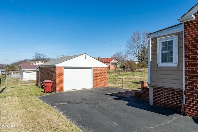 detached garage with driveway and fence