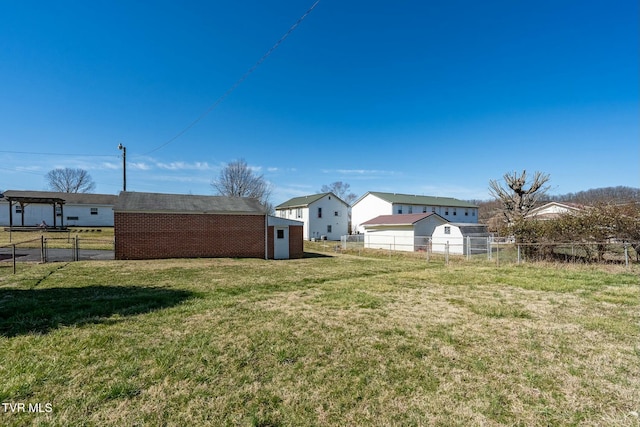 view of yard with an outdoor structure and fence