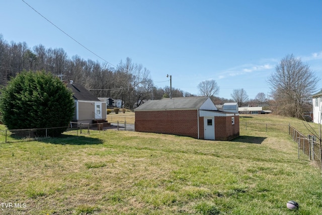 view of yard featuring an outbuilding and fence